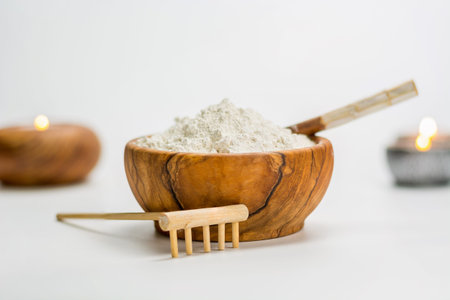 Wooden Bowl full of white clay ready to be used in treatment for the faceの写真素材