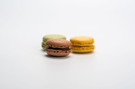 several small macarons of different flavors on a white background