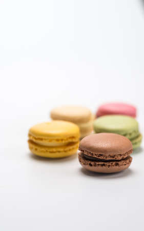 several small macarons of different flavors on a white backgroundの写真素材
