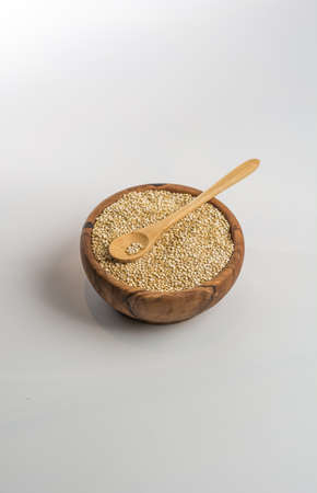 Wooden Bowl full of quinoa. Macrobiotic or vegno with much vegetable protein foodの写真素材