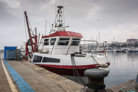 Photograph of a fishing port on a cloudy day. The port is located in Blanes, Spainの写真素材