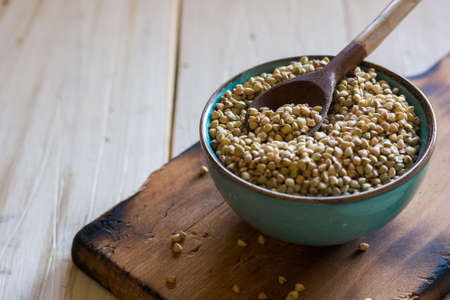 Bowl ceramic filled with buckwheat and accompanied by other cereals wheat flakes. Ideal dish for vegetariansの写真素材