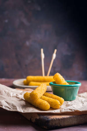 Mozzarella sticks coated with hot sauce. Aperitif to accompany mealsの写真素材