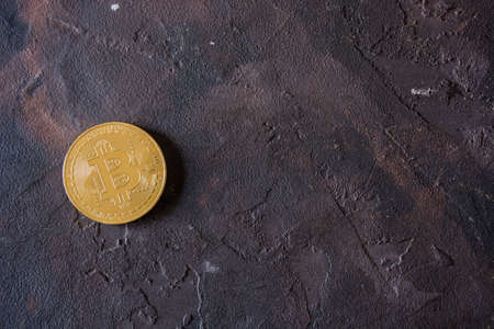 Bitcoin gold cryptocurrency buried in black stones. The money of the futureの写真素材