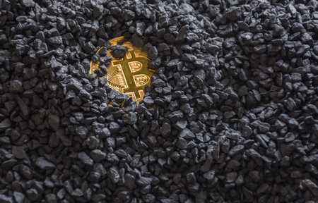 Bitcoin gold cryptocurrency buried in black stones. The money of the future