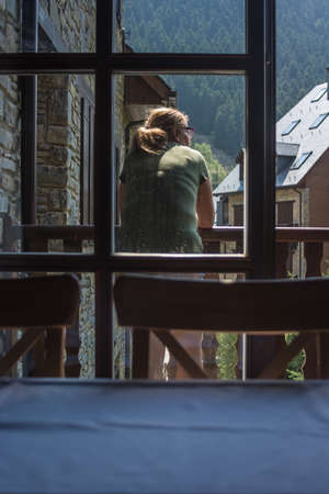 Woman on the balcony of her room enjoying a sunny dayの写真素材
