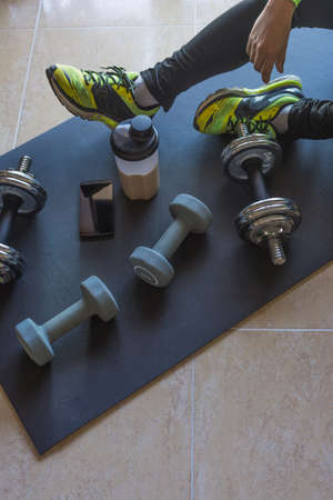 Dumbbell and mat training at home, and to drink a protein shakeの写真素材
