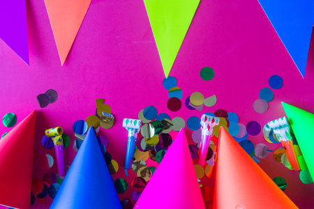 birthday celebration with paper hats, confetti, candles and party blowers