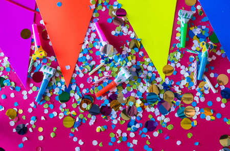 birthday celebration with paper hats, confetti, candles and party blowers