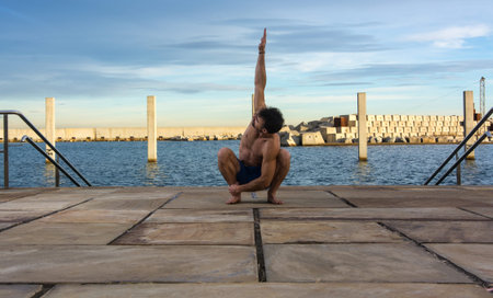 Man performing advanced yoga exercises and stretching to keep the body healthy