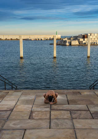 Man performing advanced yoga exercises and stretching to keep the body healthyの写真素材