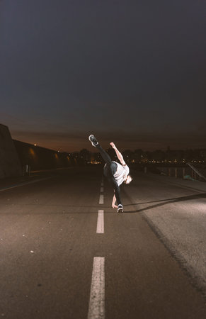 young sportsman practicing parkour, acrobatics and deadly jumps in the streets of the city