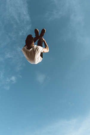 young sportsman practicing parkour, acrobatics and deadly jumps in the streets of the cityの写真素材