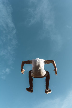 young sportsman practicing parkour, acrobatics and deadly jumps in the streets of the city