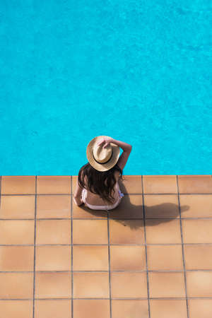 16 year old girl sunbathing peacefully in the pool of her house one summer afternoonの写真素材