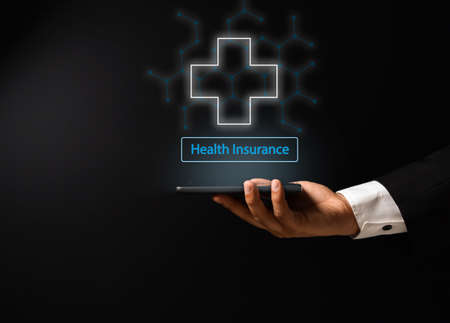 man's hand with conceptual design on medicine and health insuranceの写真素材