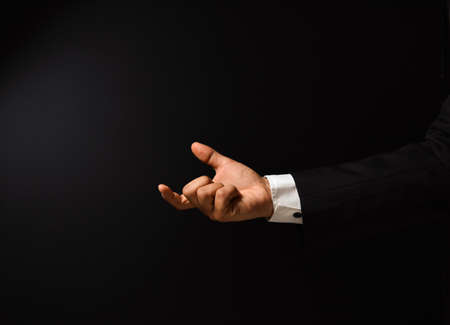 Businessman's hand on black background to add text with expressions and cards