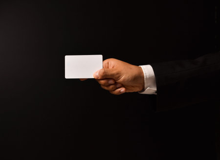 Businessman's hand on black background to add text with expressions and cards