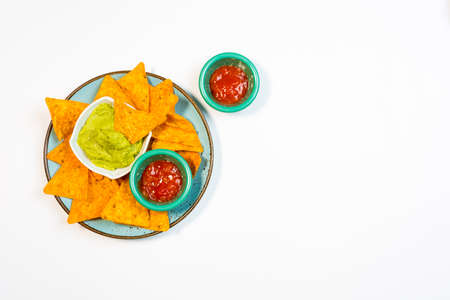 Nachos with guacamole on a white background. Typical aperitif of Mexican food.の写真素材