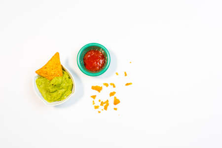 Guacamole sauce and spicy sauce accompanied by nachos. Mexican food appetizersの写真素材