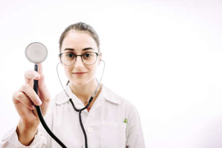 Doctor with stethoscope and white coat on a white background.の写真素材