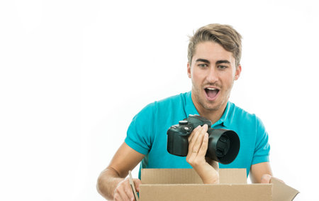 Boy surprised to receive a photo camera as a giftの写真素材