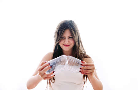 Girl collecting plastic bottles to recycle themの写真素材