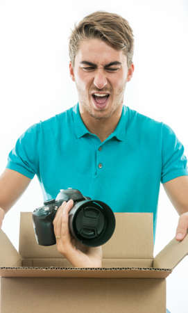 Boy surprised to receive a photo camera as a giftの写真素材