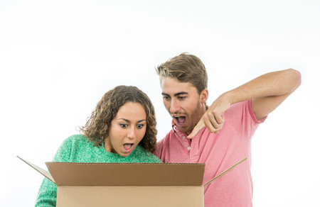 Couple very surprised to open a cardboard box and see the contents inside