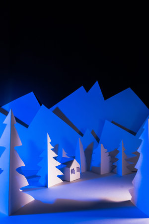 Snowy landscape of high mountain with white pines, and house in the middle of the landscape. Composition made in paperの写真素材