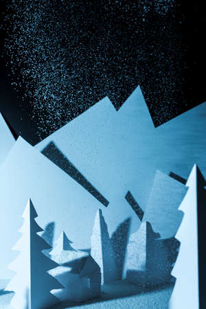 Snowy landscape of high mountain with white pines, and house in the middle of the landscape. Composition made in paperの写真素材