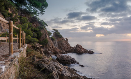 Sunrise on the beach of Blanes in the heart of Costa Brava in Spain. Coastal landscape with rocks...
