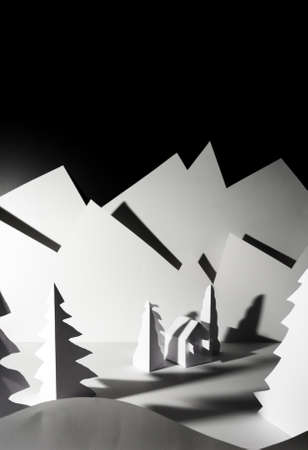 Snowy landscape of high mountain with white pines, and house in the middle of the landscape. Composition made in paperの写真素材