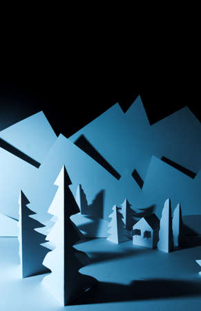 Snowy landscape of high mountain with white pines, and house in the middle of the landscape. Composition made in paperの写真素材