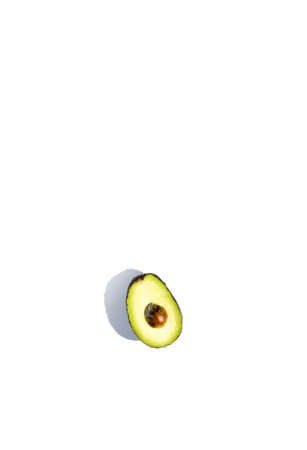 Avocados cut on a background of color and reflected shadows of palm leafの写真素材