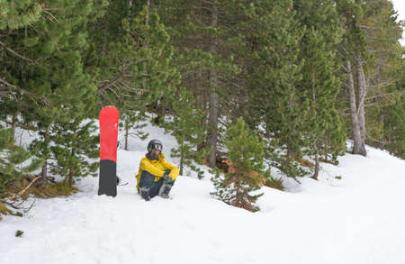 Free rider with snowshoes and snowboard on his back, contemplating the snowy landscape around himの写真素材
