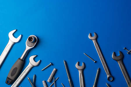 Wrenches of different sizes accompanied by screws of various sizes and with copy space to put design elementsの写真素材