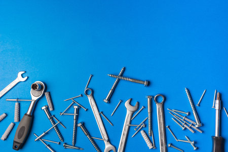 Wrenches of different sizes accompanied by screws of various sizes and with copy space to put design...