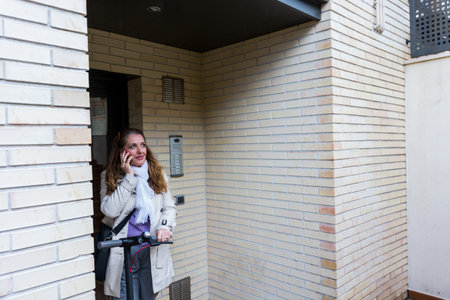 Woman prepares to go to work with her electric scooter to help the environment