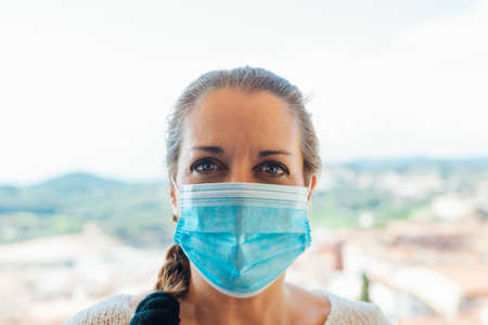 Woman on the street with a mask of protection against diseases or viruses such as covid19の写真素材