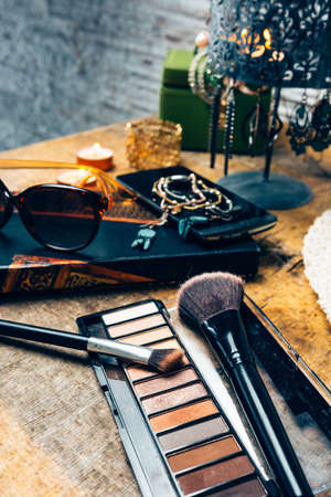 Make-up products for women on a table accompanied by different accessoriesの写真素材