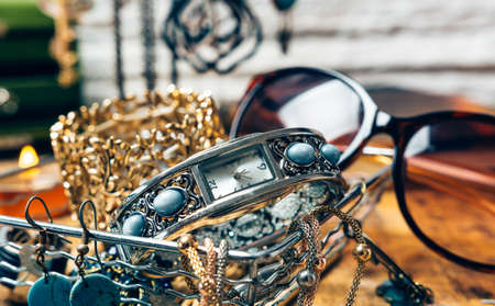Desk full of accessories for women. We find makeup, smart phones, agenda, jewelry and sunglassesの写真素材