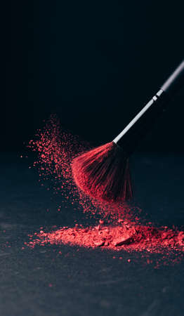Make-up brush with violet powder explosion on blackの写真素材