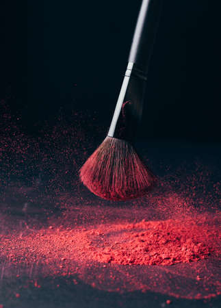 Make-up brush with violet powder explosion on blackの写真素材