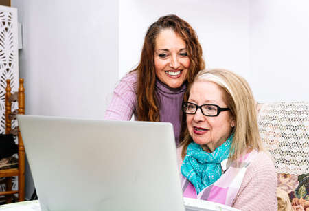 78-year-old grandmother using a laptop at home (concept of technologies for the elderly)の写真素材