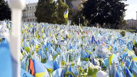 Many small blue-yellow flags with names of the dead war against russia. Memorial of the fallen...