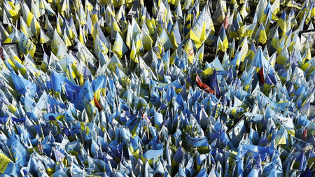Many small blue-yellow flags with names of the dead war against russia. Memorial of the fallen...