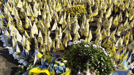 Many small flags of Ukraine with names of the dead war against russia. Memorial of the fallen soldiers, children, women in the center of Kyiv. Concept of tragedy and misfortune. Closeupの写真素材