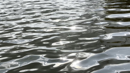 Scenery surface of pond illuminated by sun at summertime. Calm view on sea with small waves at sunny day. Beautiful summer nature landscape. Concept of tranquility scene. Slow motionの写真素材