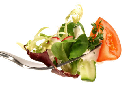 Mixed salad on a fork isolated on white backgroundの写真素材